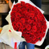 Large bouquet of red roses wrapped in white paper