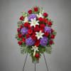 Standing floral spray with red roses, purple hydrangeas, and white lilies