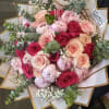 Hand-tied bouquet of pink and red roses with eucalyptus