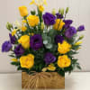 Hand selected fowers in royal purple and golden yellow arranged with artistry