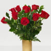 Red roses arranged in a gold vase