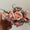 Small pink rose corsage with ribbon and tiny purple filler flowers
