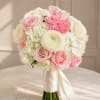 Pink and white bridal bouquet with roses, hydrangeas, and ranunculus tied with satin ribbon