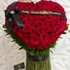 Heart-shaped bouquet of red roses with a black ribbon and birthday banner