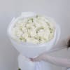 Large bouquet of white roses wrapped in white paper