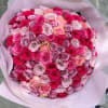 Large bouquet of pink and lavender roses wrapped in pale pink paper