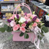 A lush mix of blush spray roses, purple tulips(seasonal), white lisianthus and