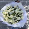 Pure white roses gathered in a lush, rounded hand-tied bouquet give this