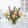 Peach Sky Elegance is a breathtaking floral arrangement featuring a harmonious blend