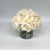 Cream rose bouquet in a clear glass vase