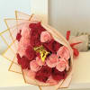 Bouquet of red and pink roses wrapped in translucent paper
