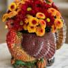 Chrysanthemums arranged in a turkey-shaped decorative container