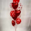 Cluster of red and white heart-shaped balloons tied together