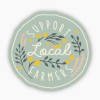 Round sign reading "Support Local Farmers" with floral graphics