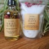 Body oil bottle and bath soak pouch on a wooden surface