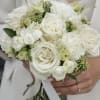A luxurious and timeless bridal bouquet featuring premium white garden roses, delicate