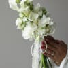 A modern and elegant bridal bouquet featuring graceful white calla lilies, soft