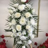 White roses and chrysanthemums arranged on a standing easel.