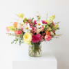 Mixed pink and white flowers arranged in a glass vase