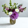 A fresh, garden-inspired arrangement featuring a bold purple ornamental kale, soft snapdragons