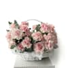 A romantic blush rose basket overflowing with soft pink blooms and fresh