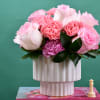 Pink roses and carnations in a white ribbed vase