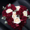 Heart-shaped bouquet of red and white roses with ribbon