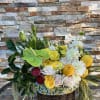 This vibrant garden basket is bursting with sunshine. Yellow roses creamy dahlias