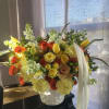 Beautiful garden roses and tulips makes this arrangement a perfect gift to