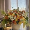 Fresh Citrus arrangement mixed with garden roses carnations and a beautiful branch