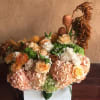 white and orange roses with fall seasonal blooms