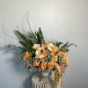 Orange roses with buttery yellow orchids