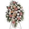 Standing floral spray with pink carnations and white daisies on a metal easel