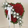 Heart-shaped red floral standing spray with white roses and ribbon