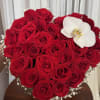 Heart-shaped bouquet of red roses with a white orchid accent