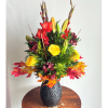 Autumn floral arrangement with red and yellow blooms in a black vase