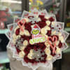 Bouquet of red and cream roses with candy canes and snowflake decorations