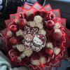 Bouquet of red and white roses with holiday ornaments and cartoon toppers