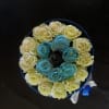Round bouquet of pale yellow and blue roses with a ribbon wrap