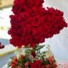 Heart-shaped red rose arrangement above a mixed red and white floral bouquet