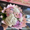 Pink and white mixed bouquet with roses and hydrangeas in decorative wrap