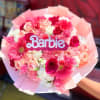 Pink and white bouquet with a Barbie sign