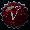 Heart-shaped bouquet of red roses with decorative crowns and cherries