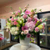 Pink and white mixed flower arrangement in a white vase