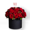 Red roses arranged in a black round box