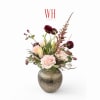Pink and burgundy floral arrangement in a textured metallic vase