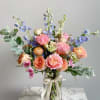 Soft and romantic, Cottage Sky features lush peach and blush roses accented