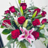 18 roses combined with stargazer lilies and accented with greenery.