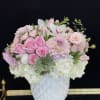 This pretty white and blush floral arrangement features Roses, Tulips, Dahlias, Spray