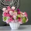 A gorgeous blend of pink shades, including Roses, Dahlias, and Ranunculus, set
